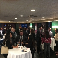 the entire room socializing with one and another over food and wine